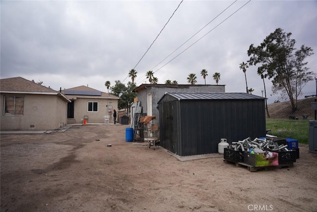 exterior space featuring an outbuilding and a storage unit