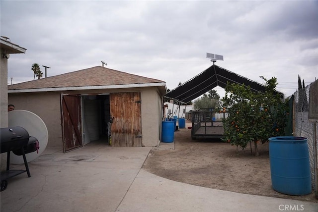 view of patio featuring a gazebo, grilling area, and an outbuilding