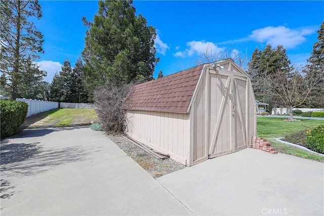 view of shed featuring fence