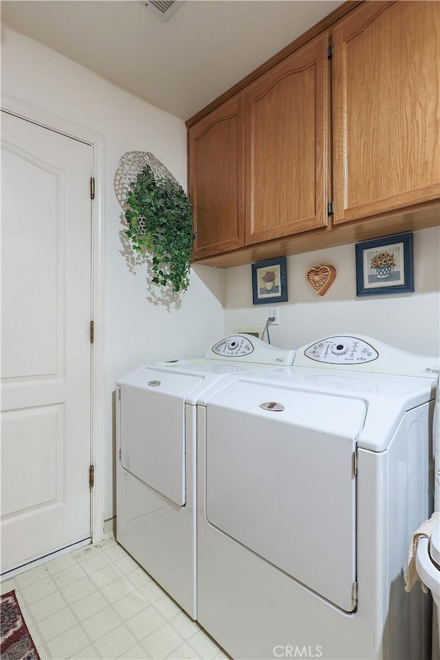 laundry room with cabinet space and washing machine and dryer