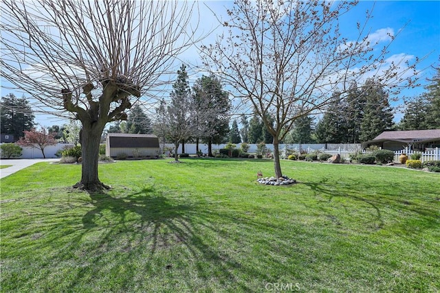 view of yard with an outdoor structure and a fenced backyard