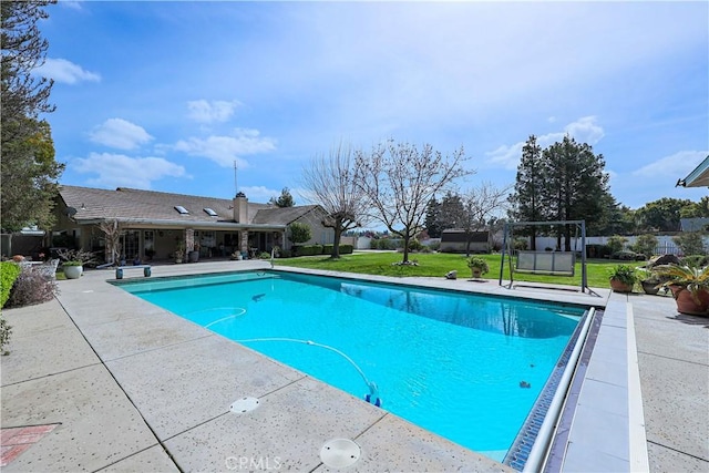 pool featuring a patio and a yard