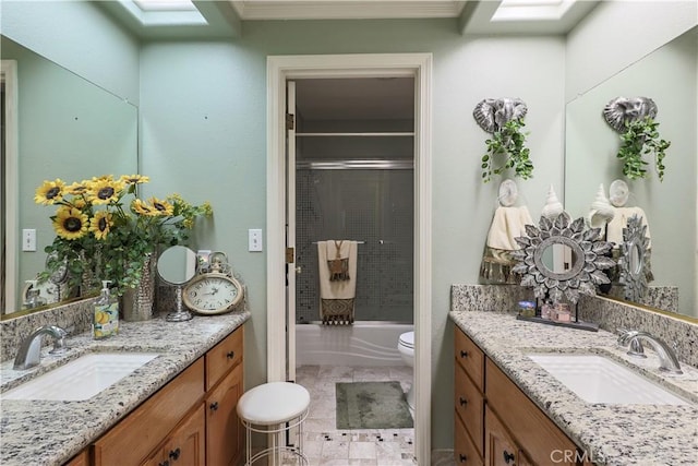 full bath featuring a sink, toilet, and two vanities