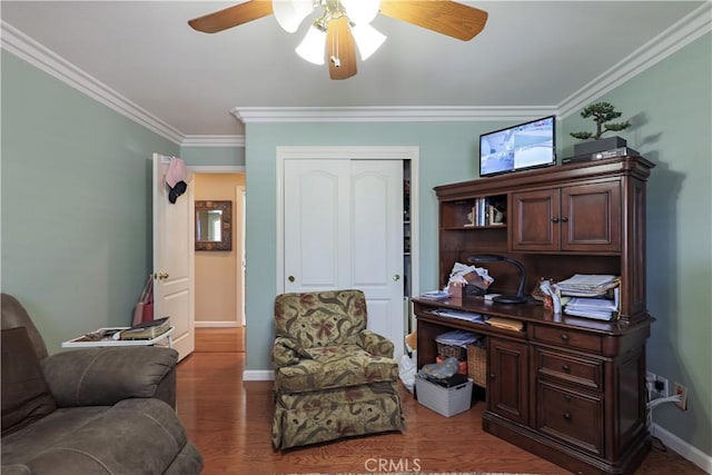 office space featuring baseboards, wood finished floors, a ceiling fan, and ornamental molding