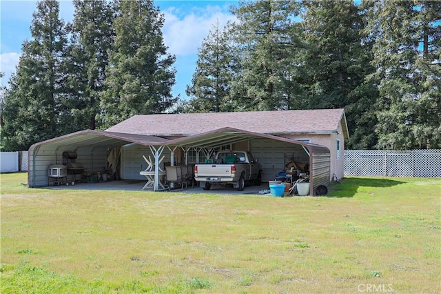 exterior space featuring a detached garage and fence