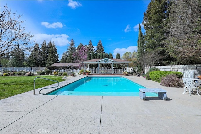 view of swimming pool featuring a patio area, a fenced in pool, a yard, and fence