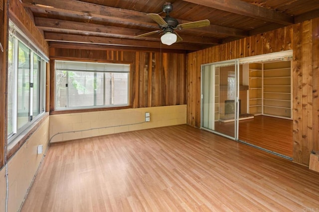 unfurnished sunroom featuring beamed ceiling