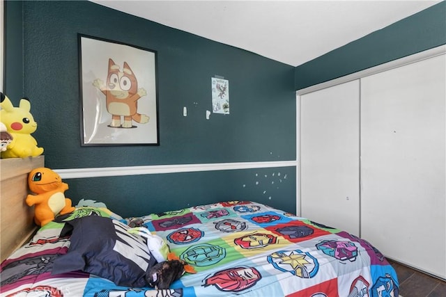 bedroom with a closet and wood finished floors