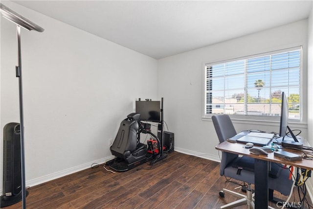 office space with baseboards, wood finished floors, and a healthy amount of sunlight