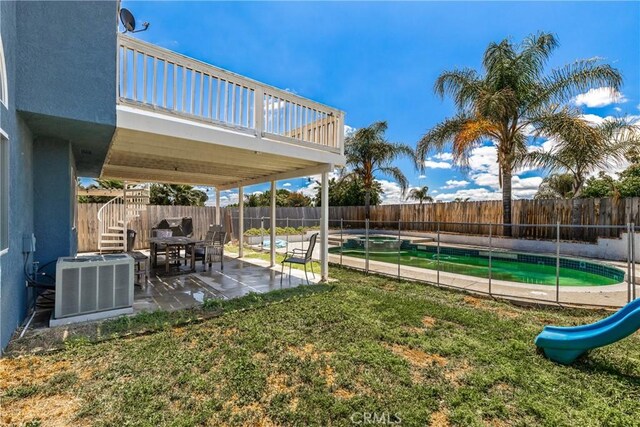 view of yard featuring a fenced in pool, central AC unit, a patio area, and a fenced backyard
