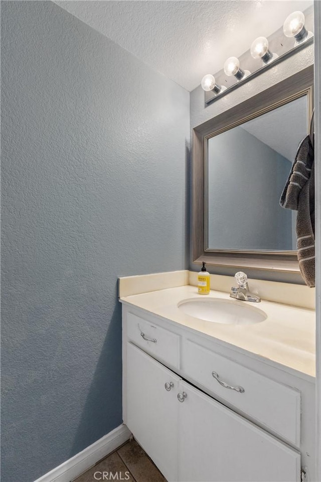 23835 Cork Oak Cir, Murrieta, CA 92562 - bathroom with a textured wall, vanity, tile patterned floors, a textured ceiling, and baseboards