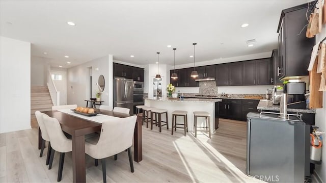 35461 Alexandria Way, Beaumont, CA 92223 - dining area with light wood-style floors, recessed lighting, and stairs