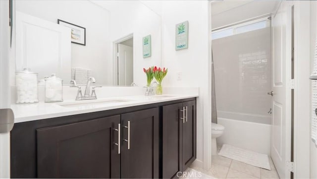 full bath with toilet and double vanity