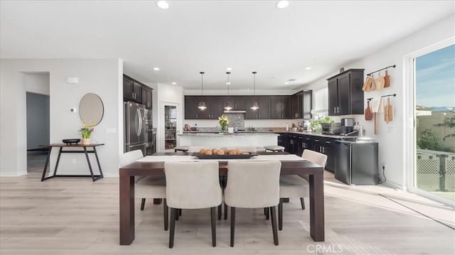 dining room with recessed lighting and light wood-style flooring