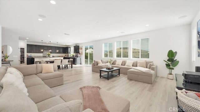 living room featuring light wood finished floors and recessed lighting