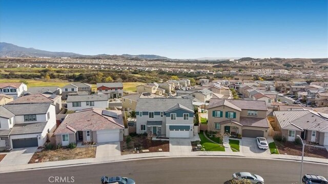 aerial view of residential area featuring mountains