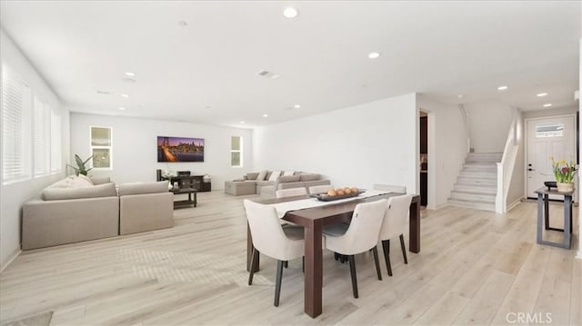dining area with stairs, recessed lighting, light wood finished floors, and baseboards