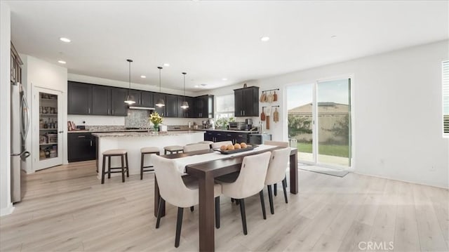 dining area with recessed lighting and light wood finished floors