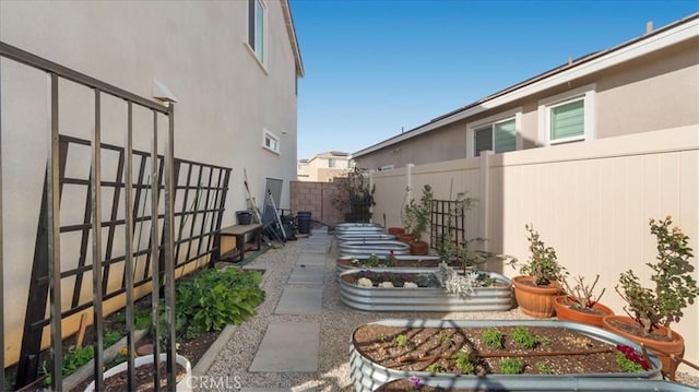 fenced backyard featuring a vegetable garden