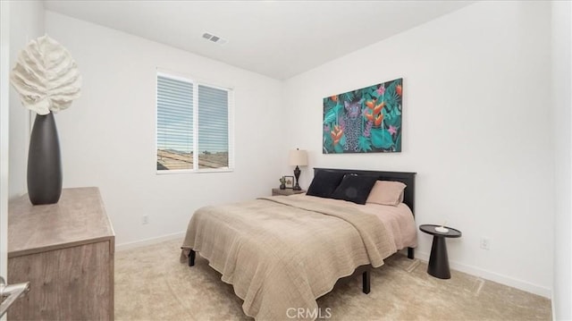 bedroom featuring light colored carpet and baseboards
