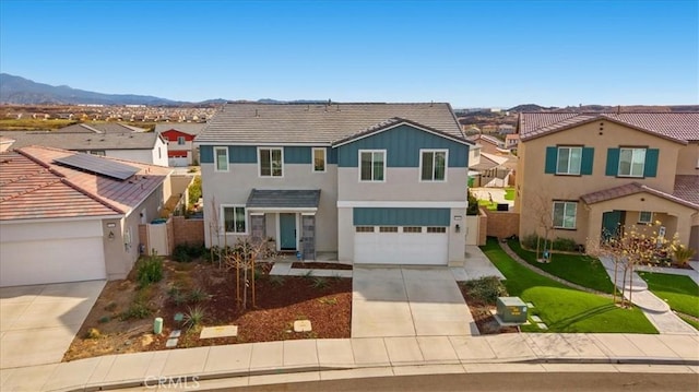 traditional-style home featuring concrete driveway, a residential view, and stucco siding