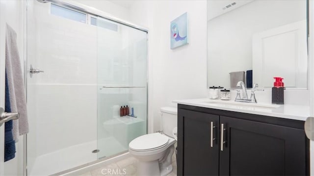 full bath with a stall shower, toilet, and vanity