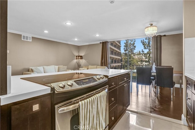 kitchen with dark brown cabinetry, stainless steel electric range oven, crown molding, and light countertops