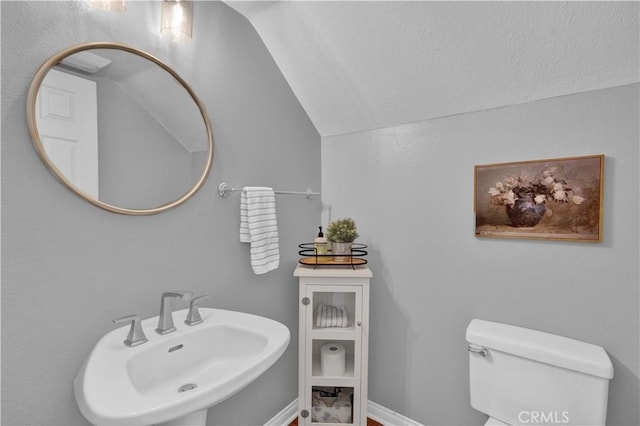 11 Spring View Way, Rancho Santa Margarita, CA 92688 - half bathroom featuring a sink, vaulted ceiling, toilet, and baseboards