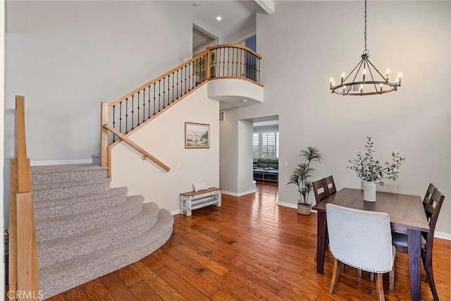 11 Spring View Way, Rancho Santa Margarita, CA 92688 - dining room with a chandelier, stairs, hardwood / wood-style floors, baseboards, and high vaulted ceiling
