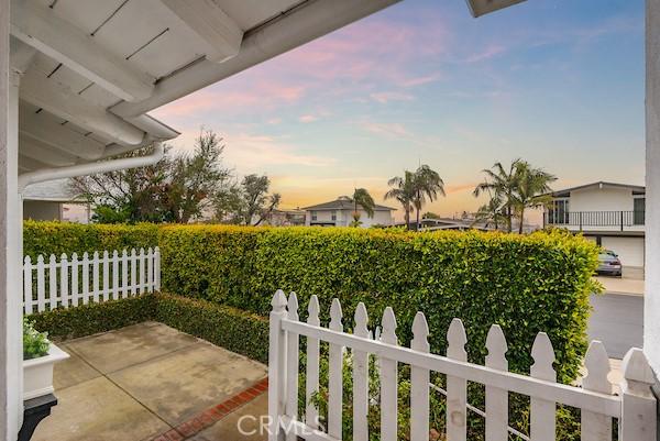 patio terrace at dusk featuring fence