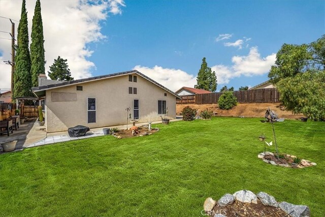 view of yard with a patio and a fenced backyard