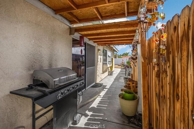 view of patio featuring grilling area and fence
