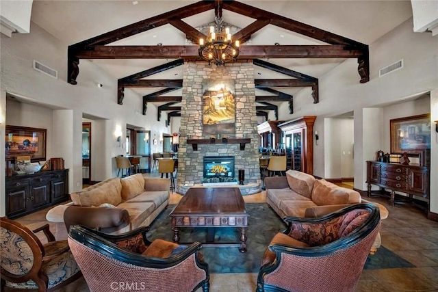 living room with visible vents, high vaulted ceiling, beam ceiling, a fireplace, and a chandelier