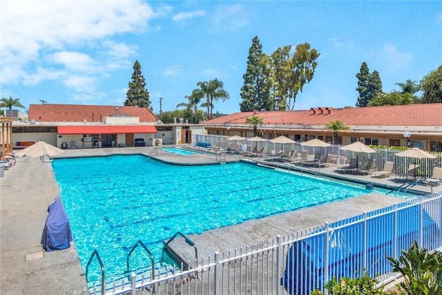 pool featuring a patio area and fence
