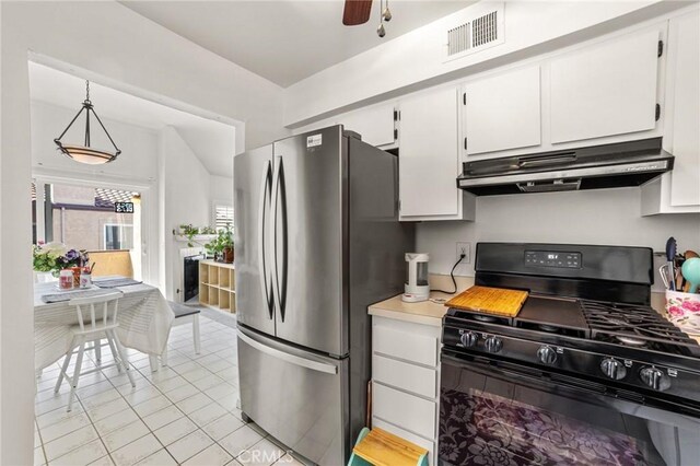 9341 E Shadowood Dr Unit E, Montclair, CA 91763 - kitchen with gas stove, under cabinet range hood, freestanding refrigerator, white cabinetry, and light tile patterned floors