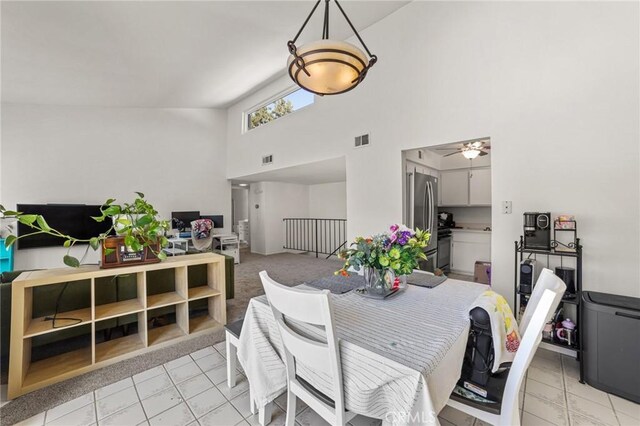 9341 E Shadowood Dr Unit E, Montclair, CA 91763 - dining area featuring a towering ceiling, light tile patterned floors, and ceiling fan