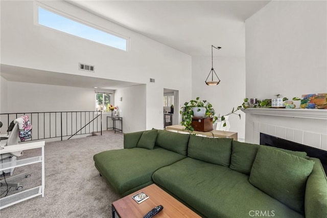 9341 E Shadowood Dr Unit E, Montclair, CA 91763 - carpeted living room with a towering ceiling and a fireplace