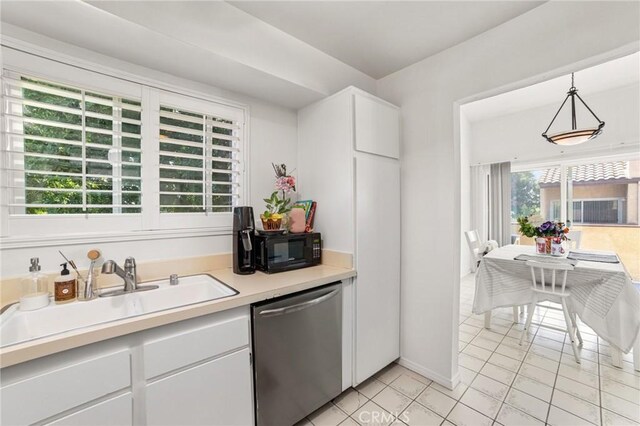 9341 E Shadowood Dr Unit E, Montclair, CA 91763 - kitchen with stainless steel dishwasher, black microwave, a sink, light countertops, and white cabinetry