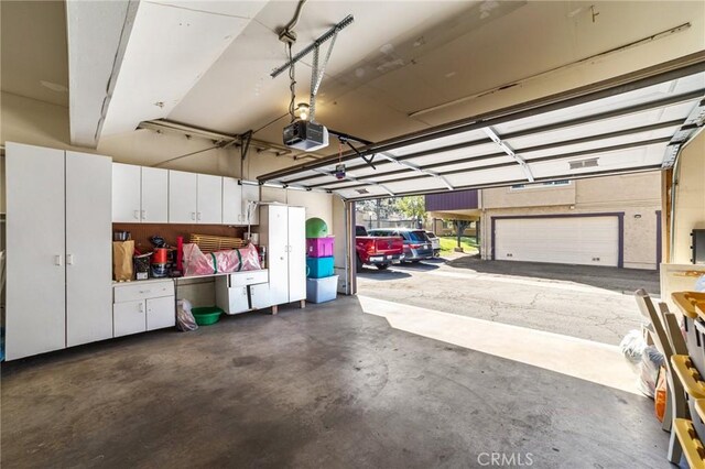 9341 E Shadowood Dr Unit E, Montclair, CA 91763 - garage featuring a garage door opener