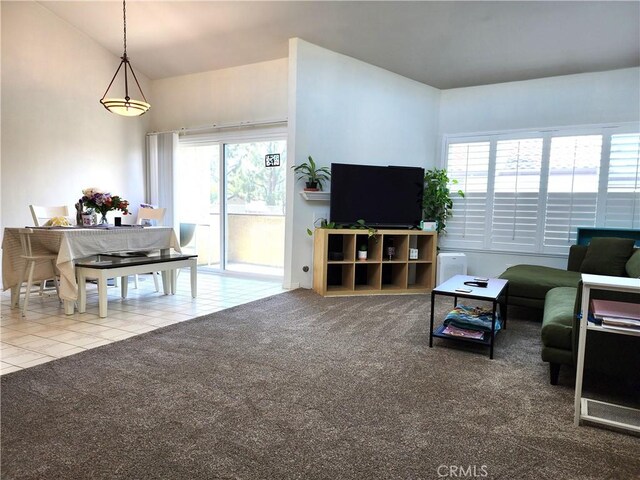 9341 E Shadowood Dr Unit E, Montclair, CA 91763 - tiled living room featuring carpet flooring and vaulted ceiling