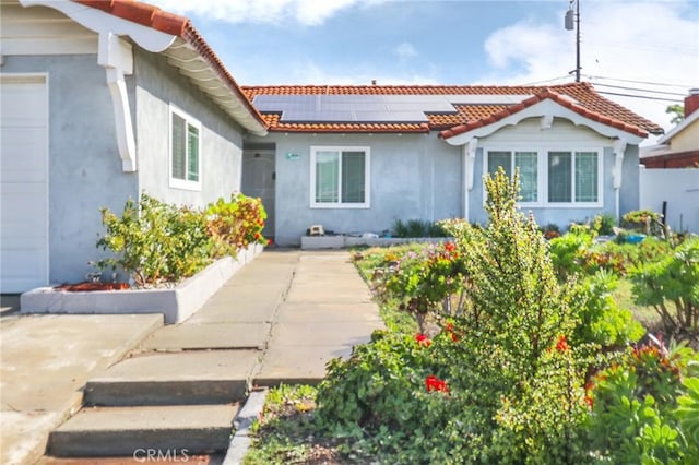 2634 Blandford Dr, Rowland Heights, CA 91748 - view of exterior entry with stucco siding, solar panels, and a tiled roof