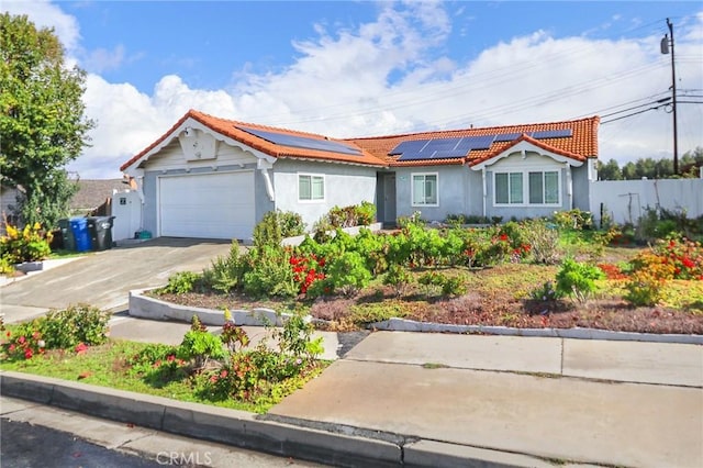 2634 Blandford Dr, Rowland Heights, CA 91748 - view of front of property featuring fence, driveway, an attached garage, a tiled roof, and roof mounted solar panels