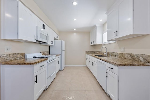 1271 E 7th St, Long Beach, CA 90813 - kitchen featuring a sink, stone countertops, white cabinets, baseboards, and white appliances