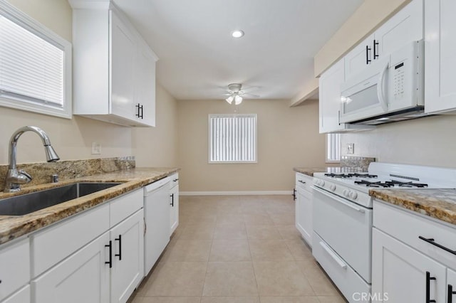 1271 E 7th St, Long Beach, CA 90813 - kitchen with a sink, white appliances, ceiling fan, white cabinets, and baseboards