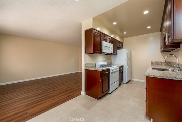 1271 E 7th St, Long Beach, CA 90813 - kitchen featuring a sink, open floor plan, baseboards, white appliances, and recessed lighting