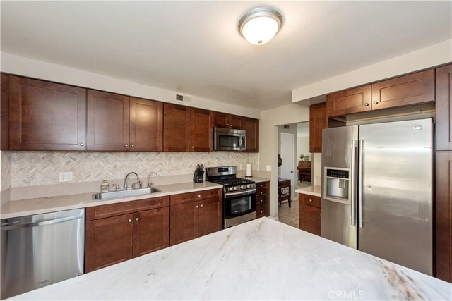 27441 Abanico, Mission Viejo, CA 92691 - kitchen with a sink, visible vents, appliances with stainless steel finishes, and decorative backsplash