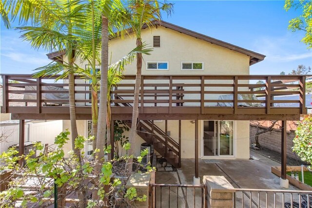 27441 Abanico, Mission Viejo, CA 92691 - rear view of house with a patio, a wooden deck, fence, and stucco siding