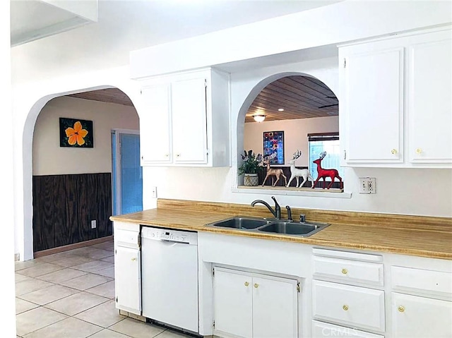 kitchen featuring a sink, white cabinetry, white dishwasher, light countertops, and light tile patterned floors