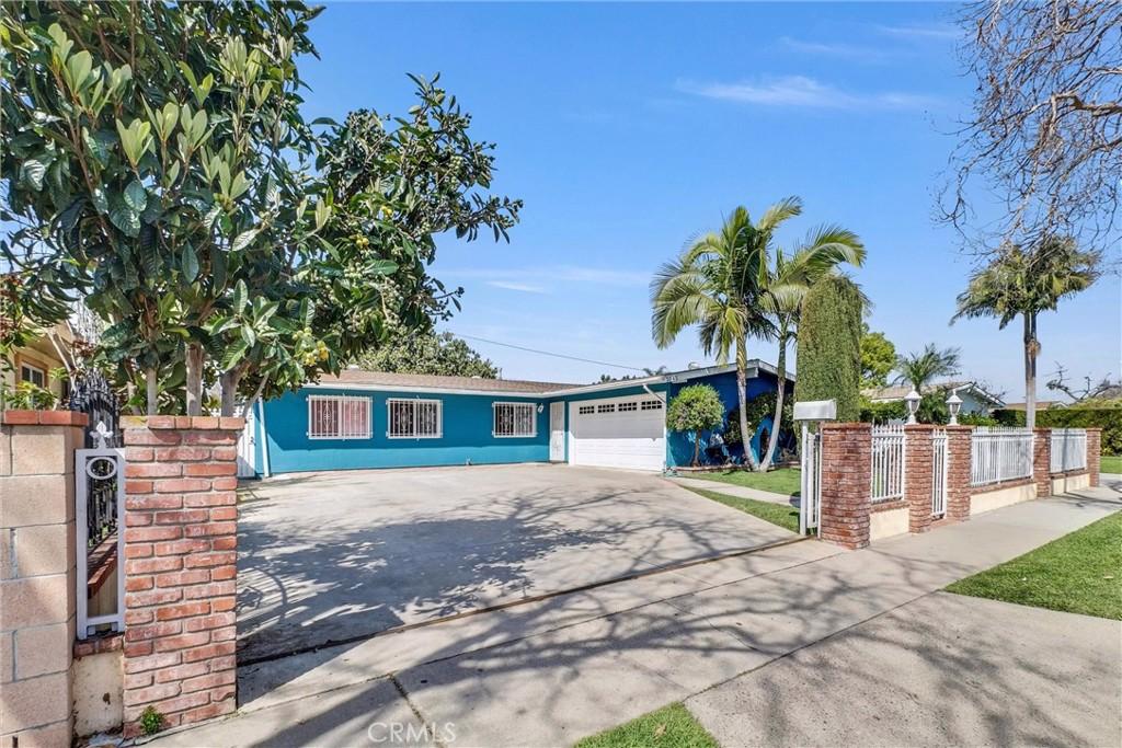 2042 S Spruce St, Santa Ana, CA 92704 - single story home with concrete driveway, a garage, and a fenced front yard