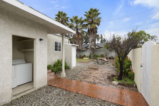 view of patio / terrace featuring washer and dryer and a fenced backyard